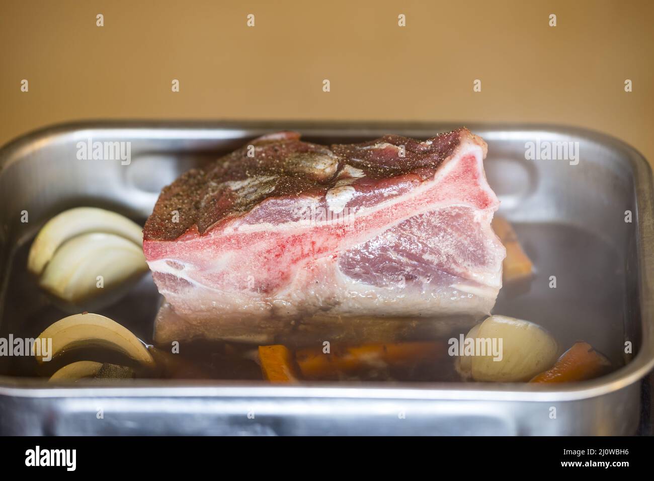 Raw pork shoulder in the baking dish Stock Photo