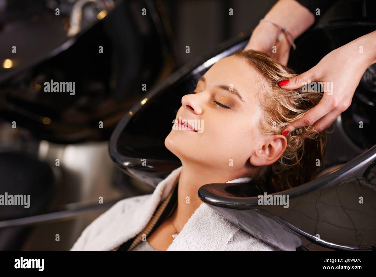 Relaxing at the salon. Shot of a young woman having her hair washed at a hair salon. Stock Photo