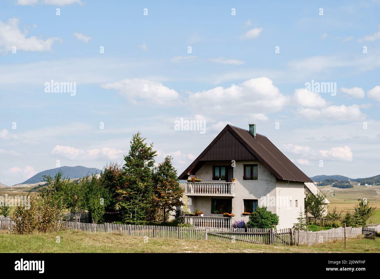 White stone house in a valley with mountains in the background. Montenegro, north Stock Photo