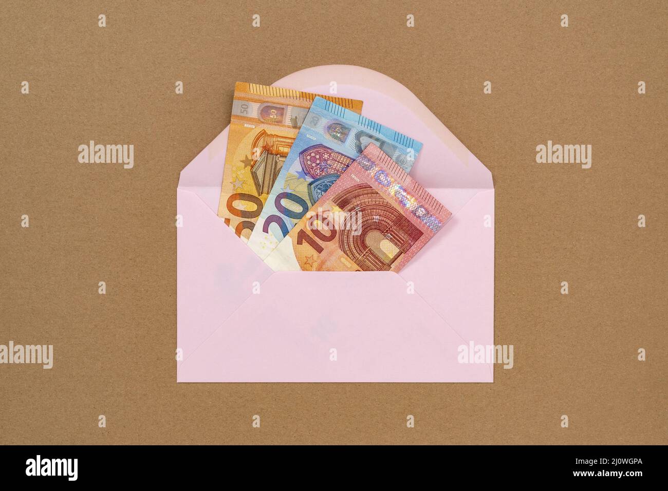 A pink envelope full of money Stock Photo - Alamy