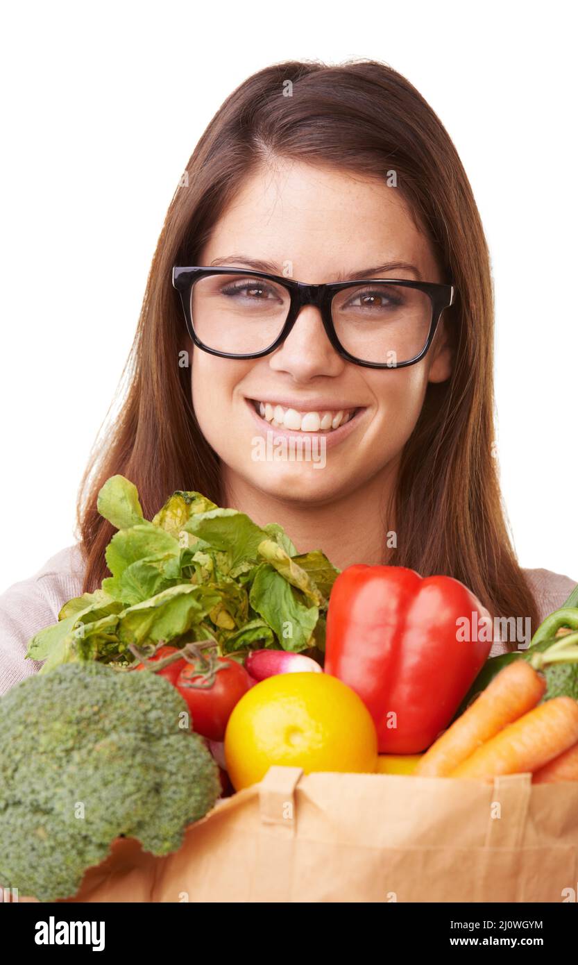 Grocery shopping. Portrait of an attractive young woman holding a bag of groceries. Stock Photo