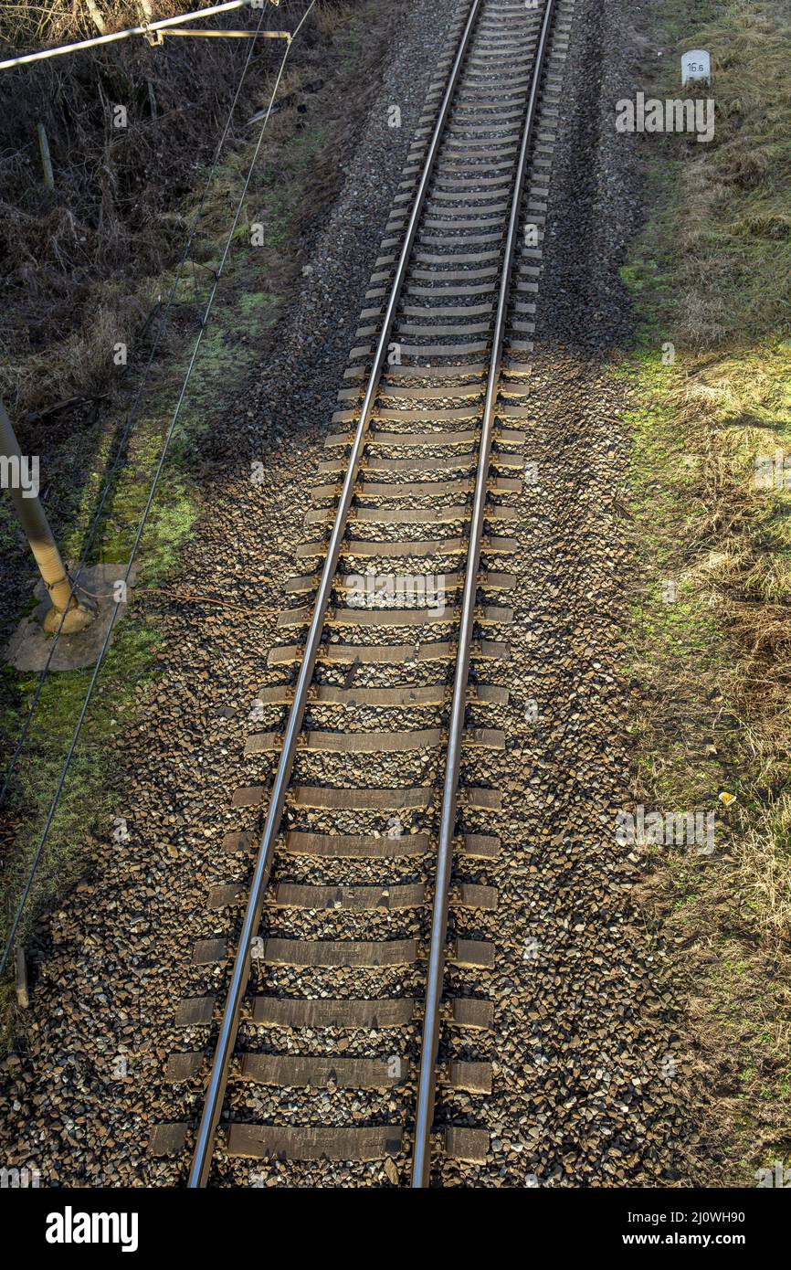 Single track railway line. Empty straight single-way railway line at sunny day. Stock Photo