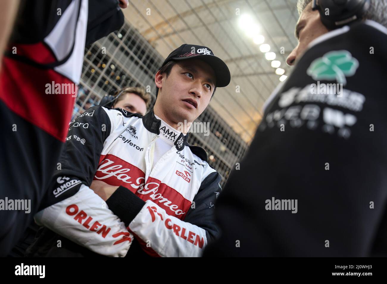 (220321) -- SAKHIR, March 21, 2022 (Xinhua) -- Alfa Romeo's Chinese driver Zhou Guanyu (C) chats with his team during the Bahrain Formula One Grand Prix at the Bahrain International Circuit in the city of Sakhir on March 20, 2022. (DPPI/Handout via Xinhua) Stock Photo