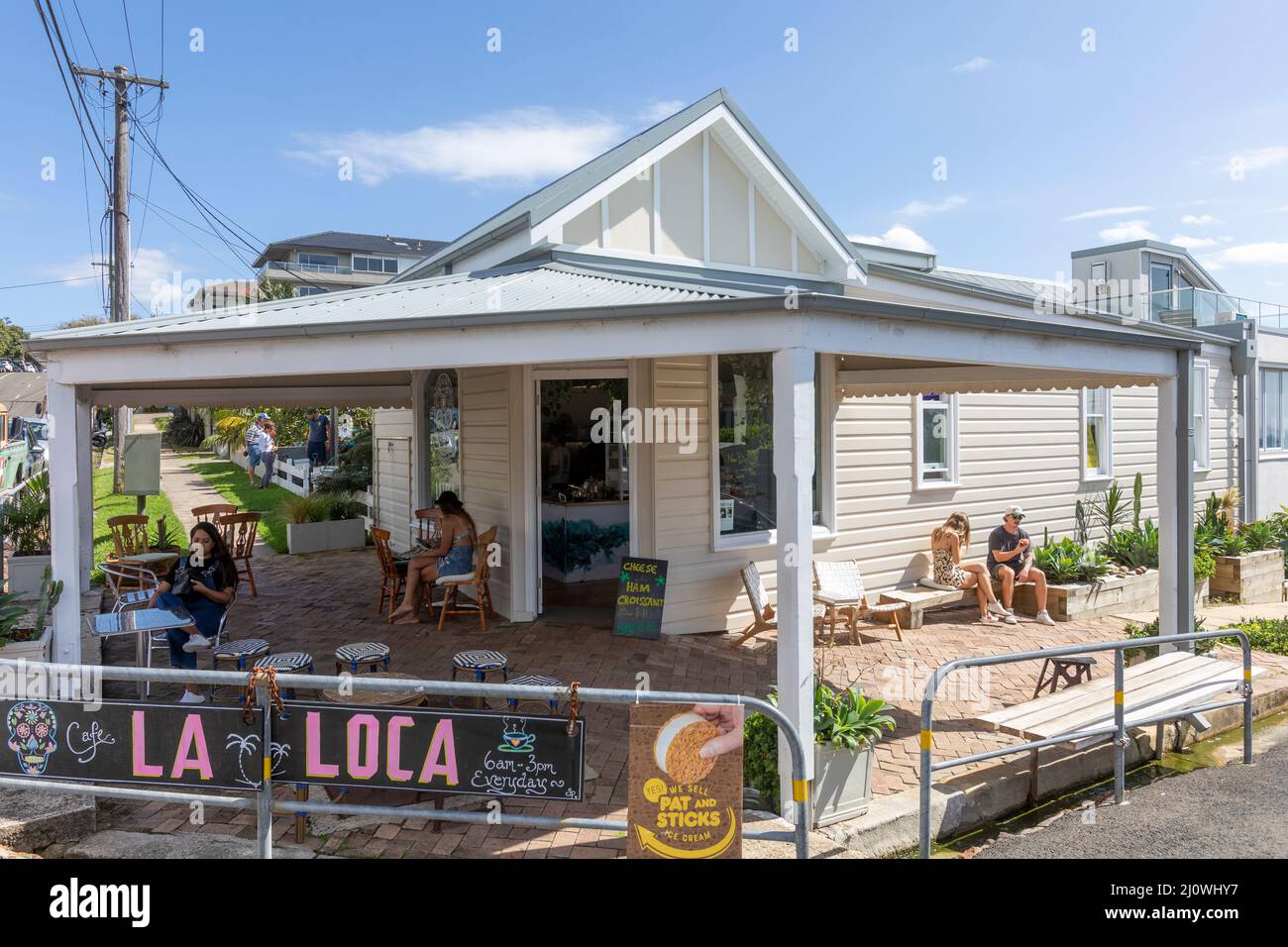 Freshwater beach suburb of Sydney with La Local cafe and coffee shop with customers eating and drinking,Sydney,NSW,Australia Stock Photo