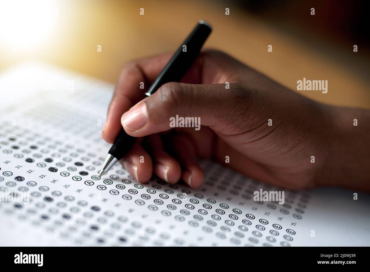 Making his choices. Cropped shot of a person filling out a multiple choice questionnaire. Stock Photo