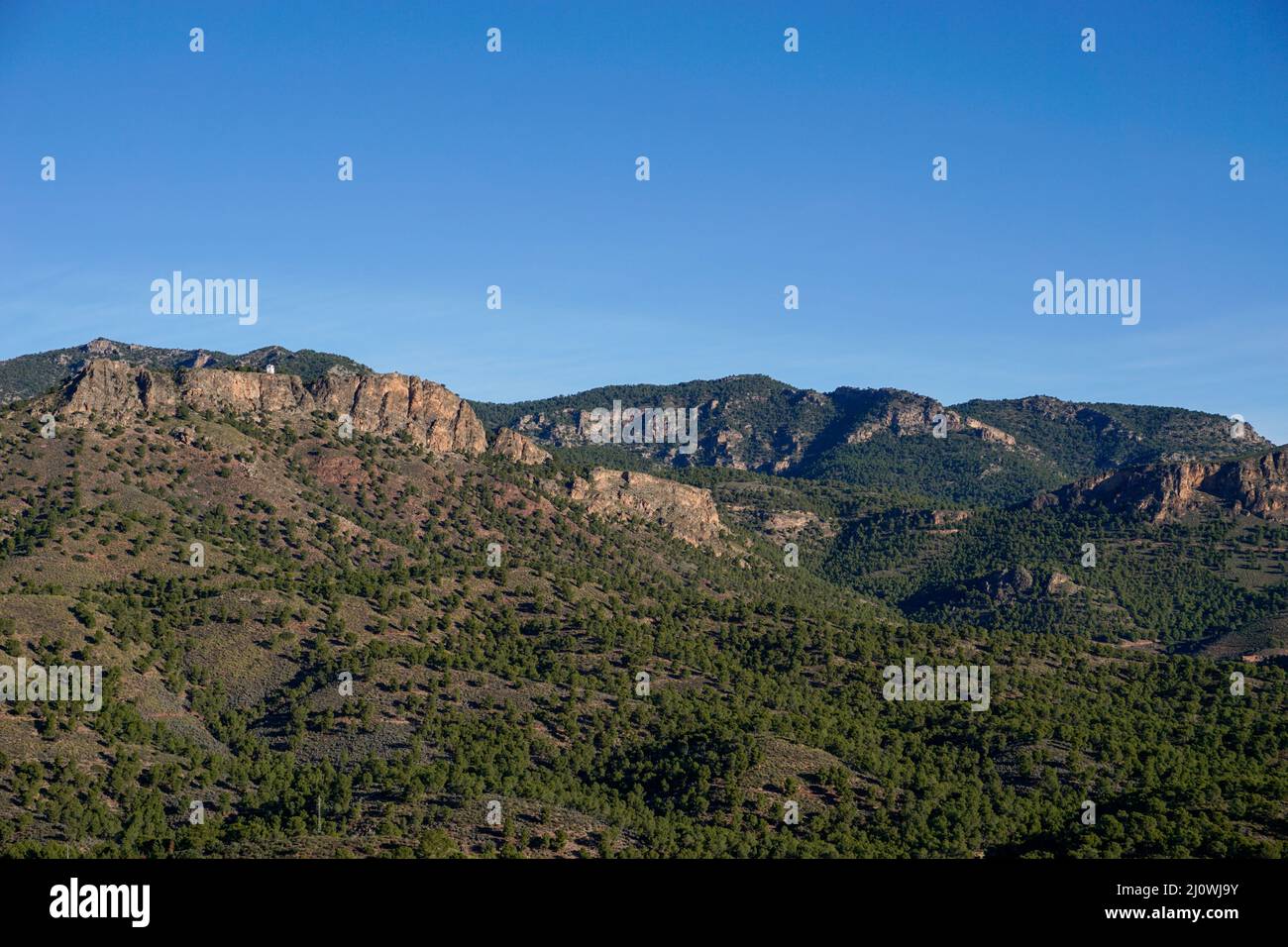 Landscape view of Spanish semi-desert with low green vegetation and mountains Stock Photo