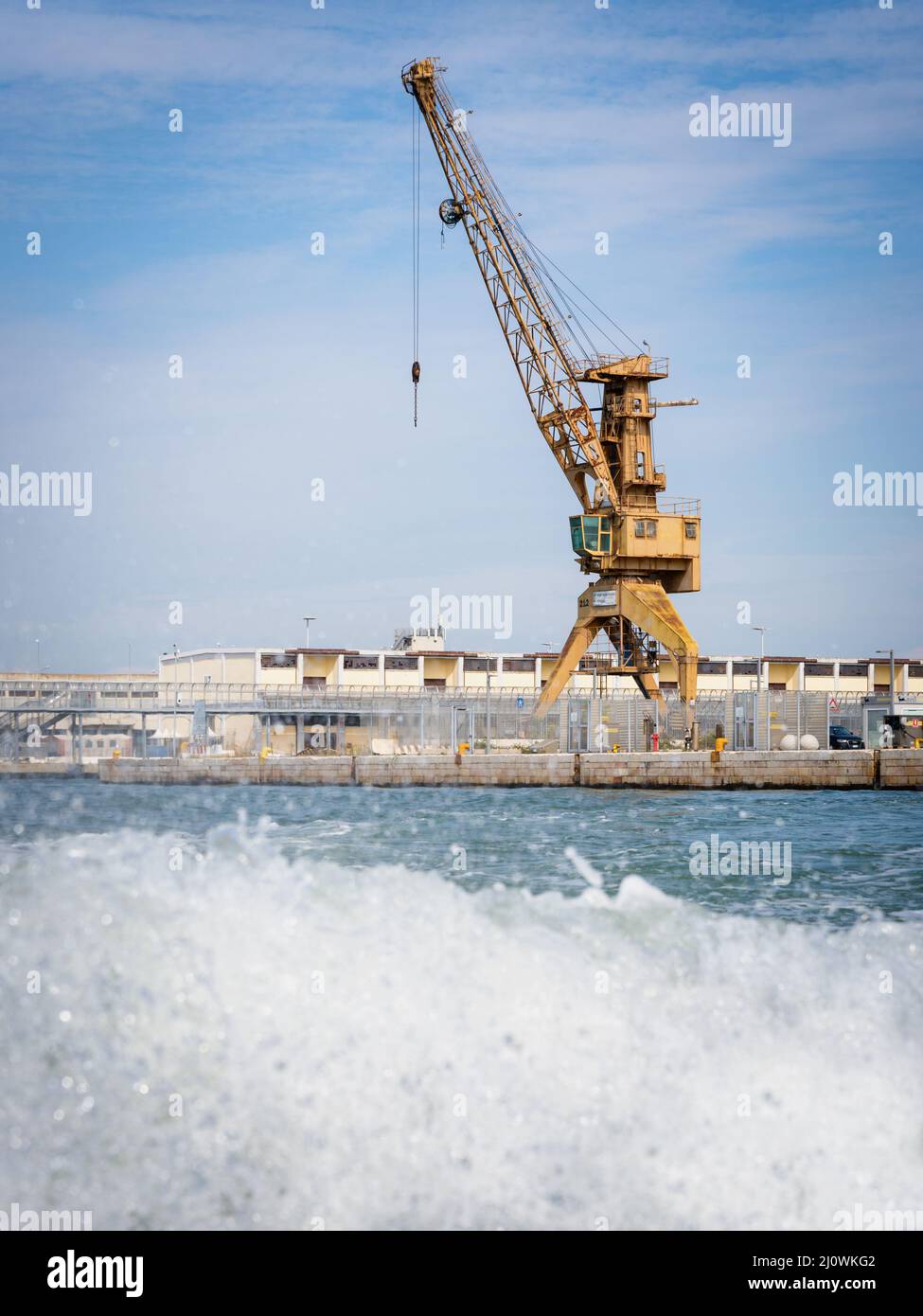 Yellow crane in cargo port translating coal. Industrial scene Stock Photo