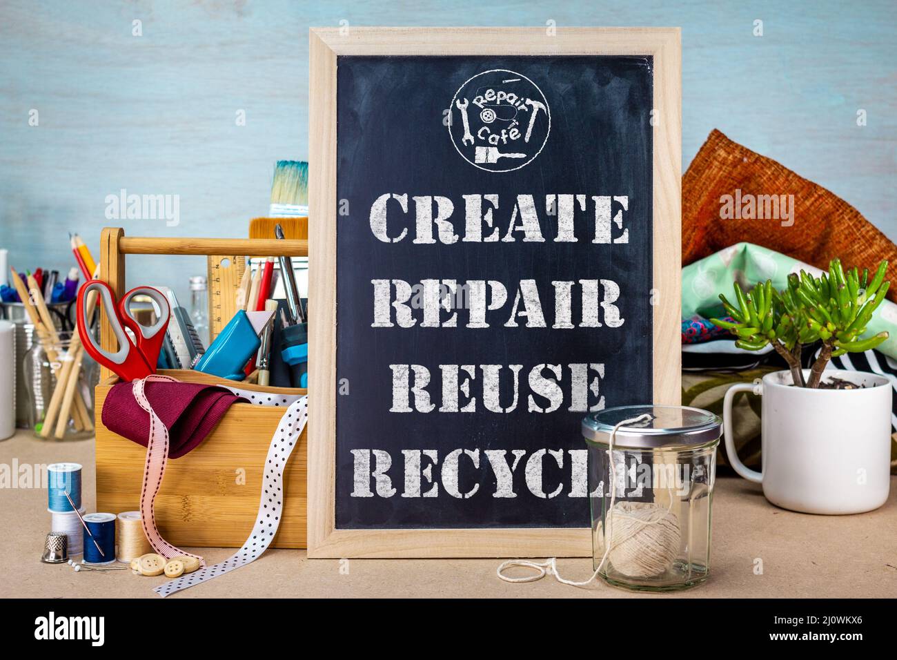 Create Repair Reuse Recycle sign at Repair cafe with tools and fabric, reduce waste for sustainable living concept Stock Photo