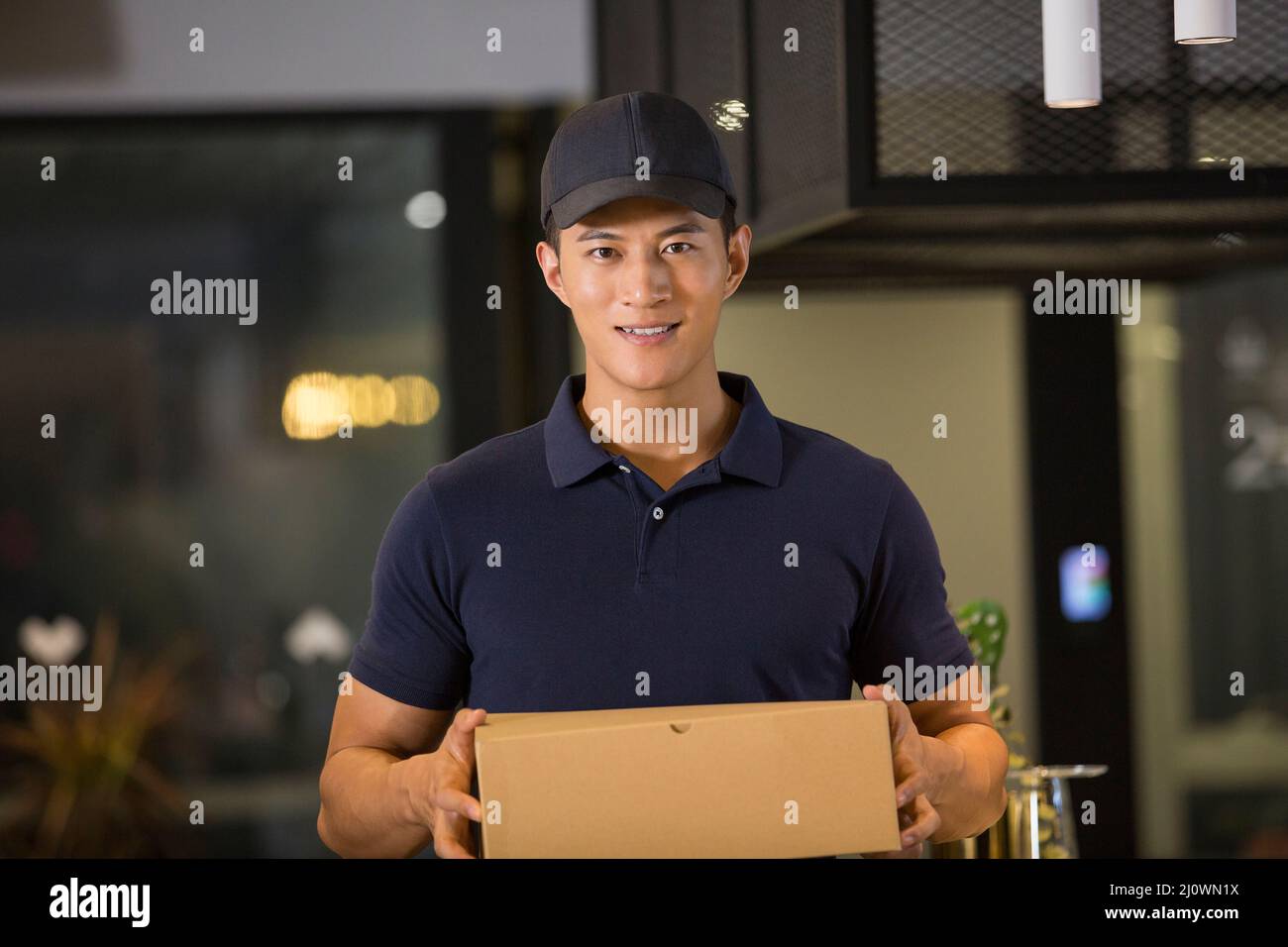 Portrait of smiling Chinese delivery man Stock Photo Alamy
