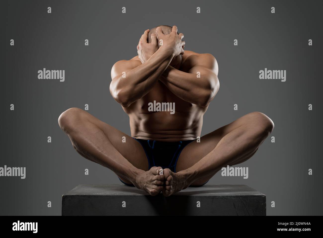 Fit man in underpants touching head in studio Stock Photo