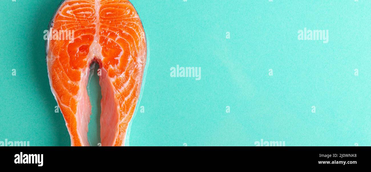 Uncooked raw fresh fish salmon steak top view on blue clean background from above Stock Photo