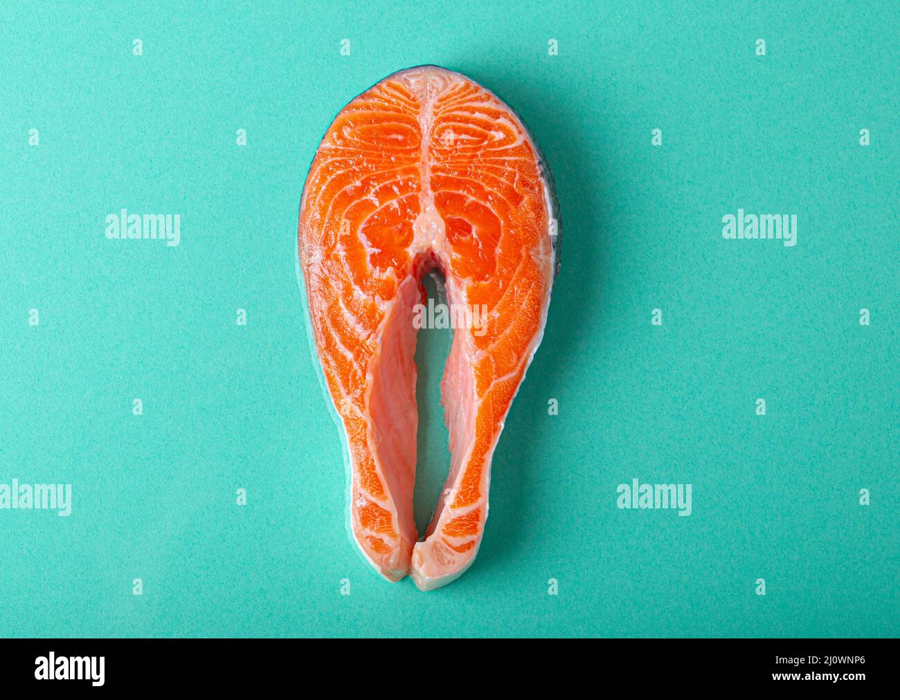 Raw fresh fish salmon steak top view on blue clean background from above Stock Photo