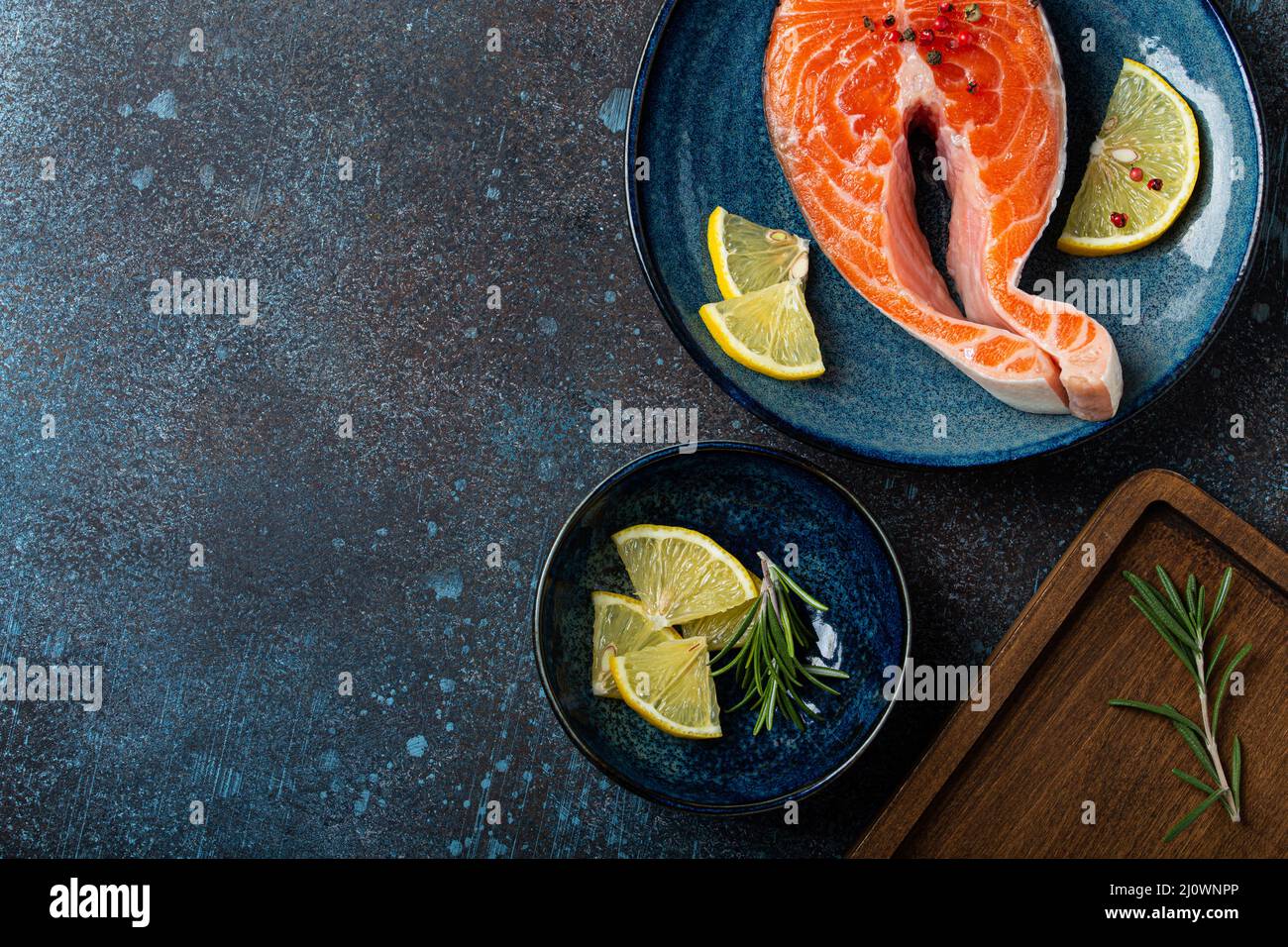 Raw fresh fish salmon steak top view on plate rustic dark concrete ...