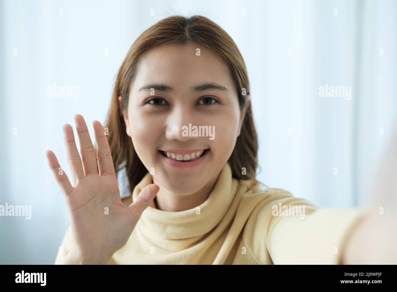 Young Asian Woman using video chat by smartphone to talking with her