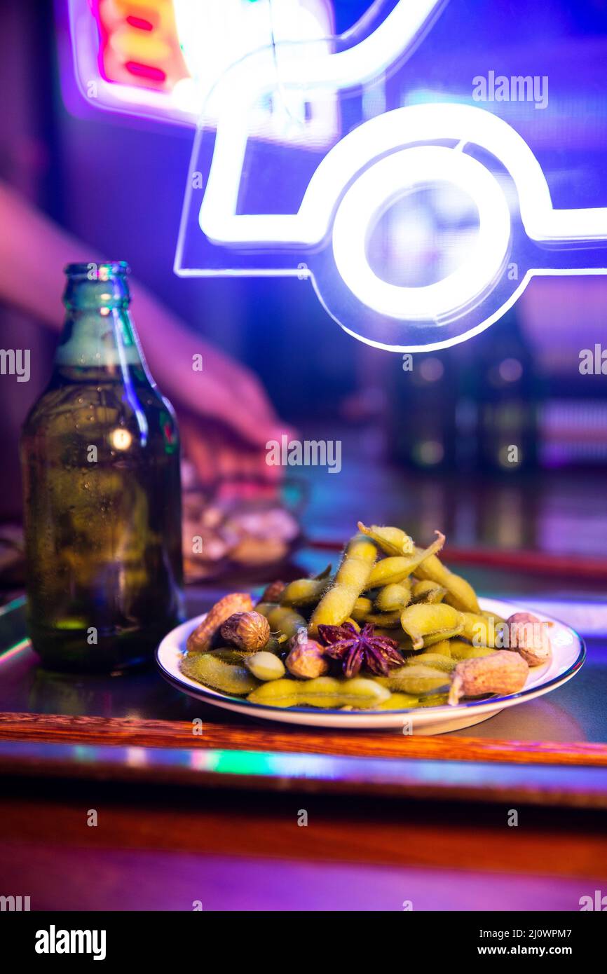 Chinese night market,Chinese beer bottle and boiled soya bean and peanut Stock Photo