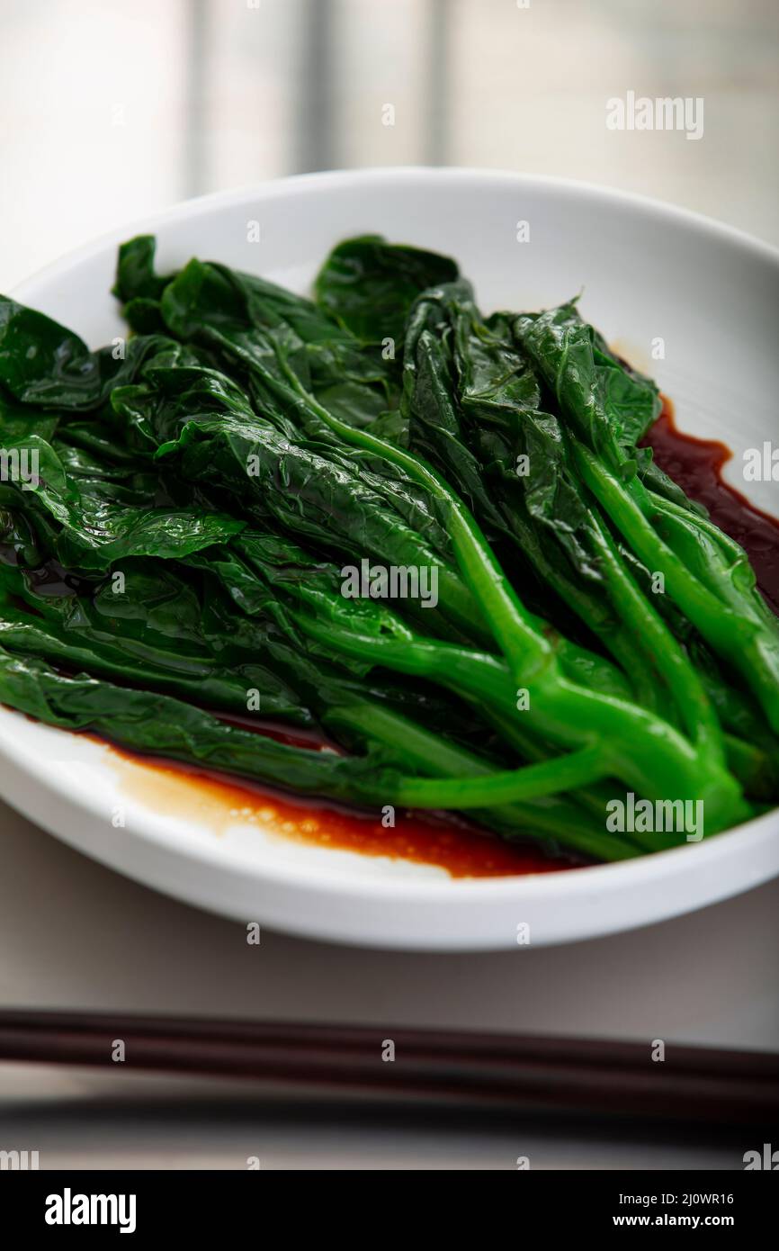 Cantonese cuisine,Closeup of boiled Chinese kale with soy sauce Stock Photo Alamy