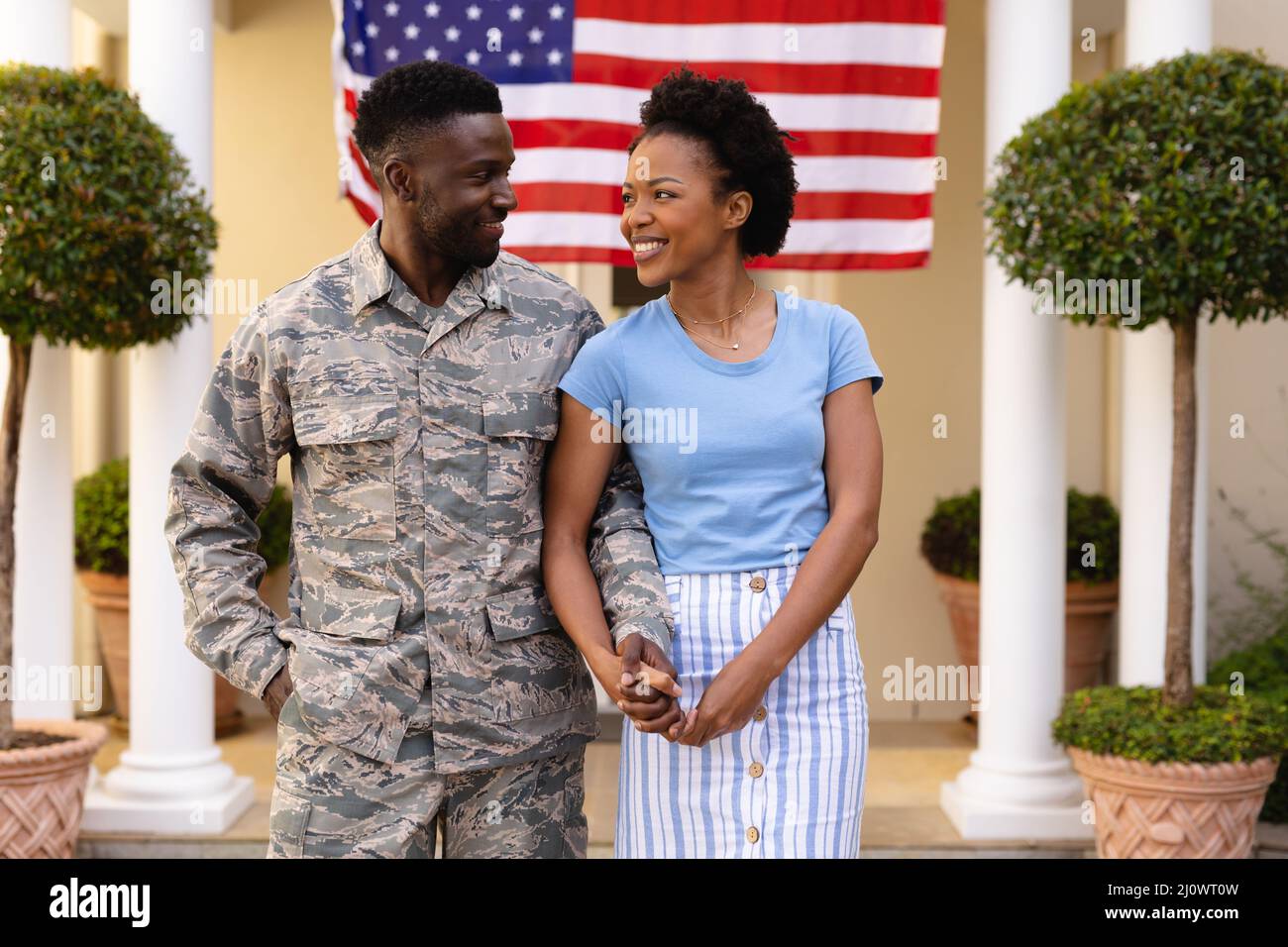 Happy african american couple holding hands looking at each other ...