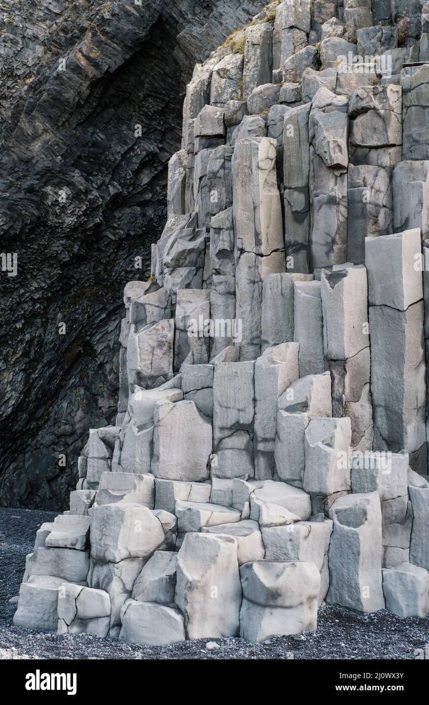 Iceland Rocks Material Basalt rock pillars columns at Reynisfjara beach near Vik, South ...
