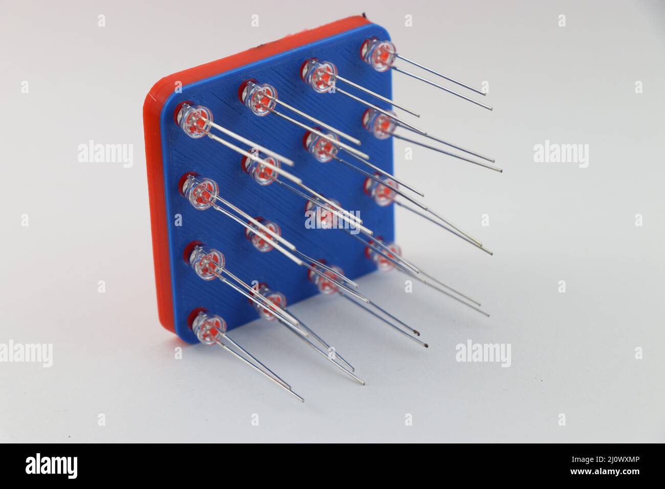 3D printed model of a 4X4 LED jig with light emitting diodes attached to its slots on a white background Stock Photo