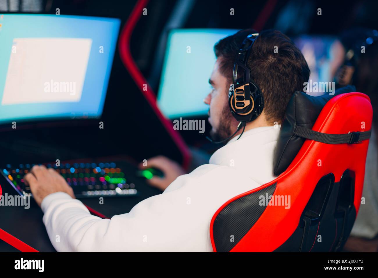 Guy playing gaming game on computer at game club Stock Photo