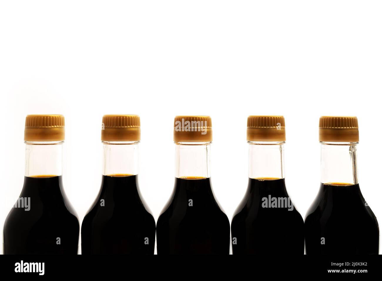 Soy sauce in glass bottle on white background. Traditional asian