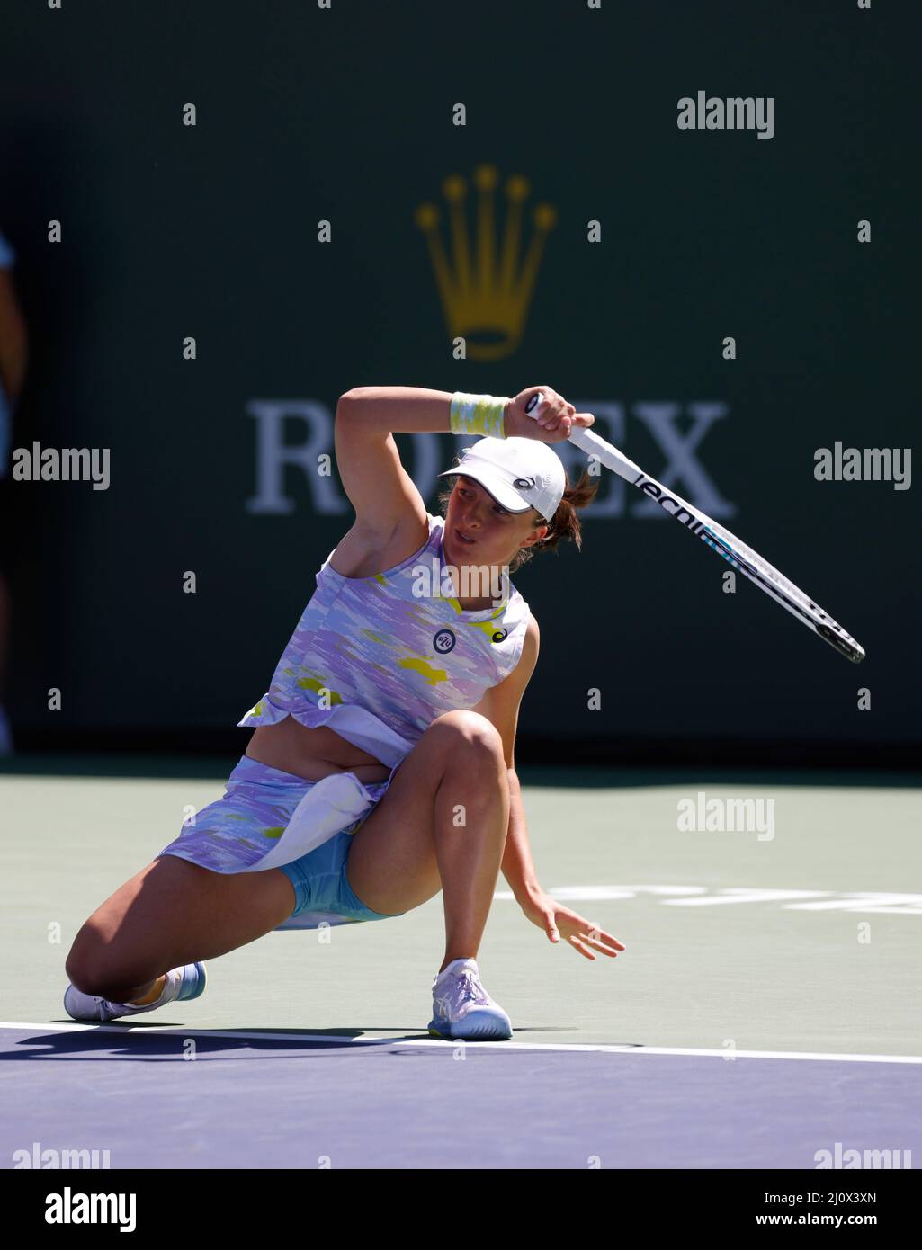 Indian Wells, California, USA. March 20, 2022 Iga Swiatek of Poland returns  a shot against Maria Sakkari of Greece in the women's singles finals of the  2022 BNP Paribas Open at Indian