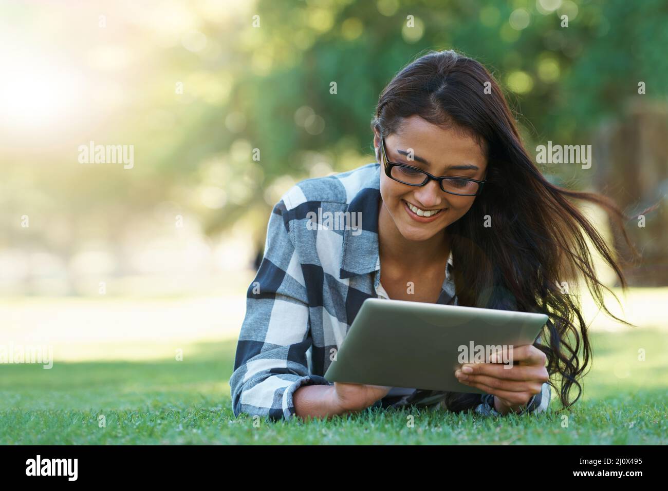 Working in the park. Young woman in a park with her laptop Stock Photo ...