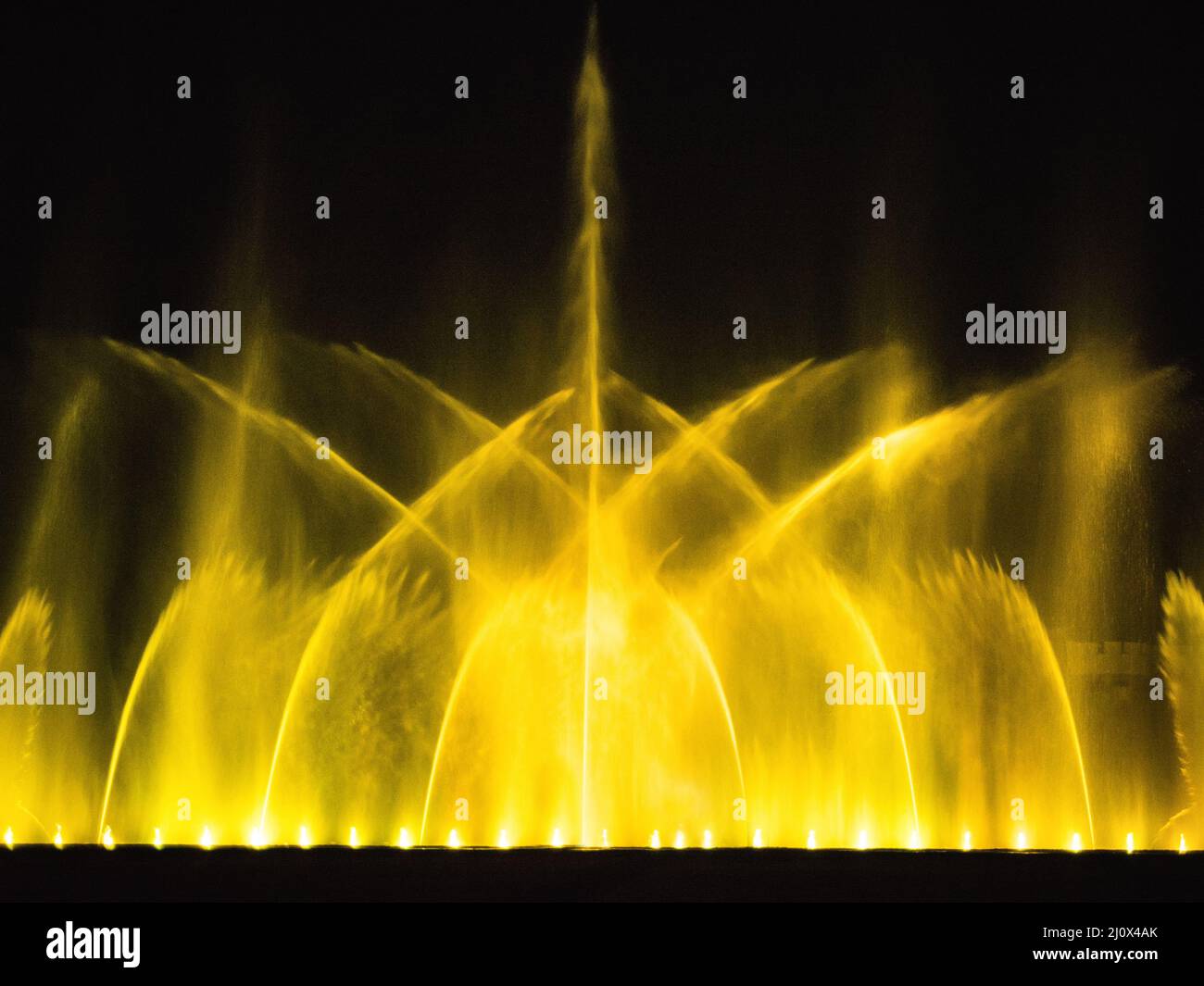 Beautiful fountain dancing show with reflection on water at night. Stock Photo
