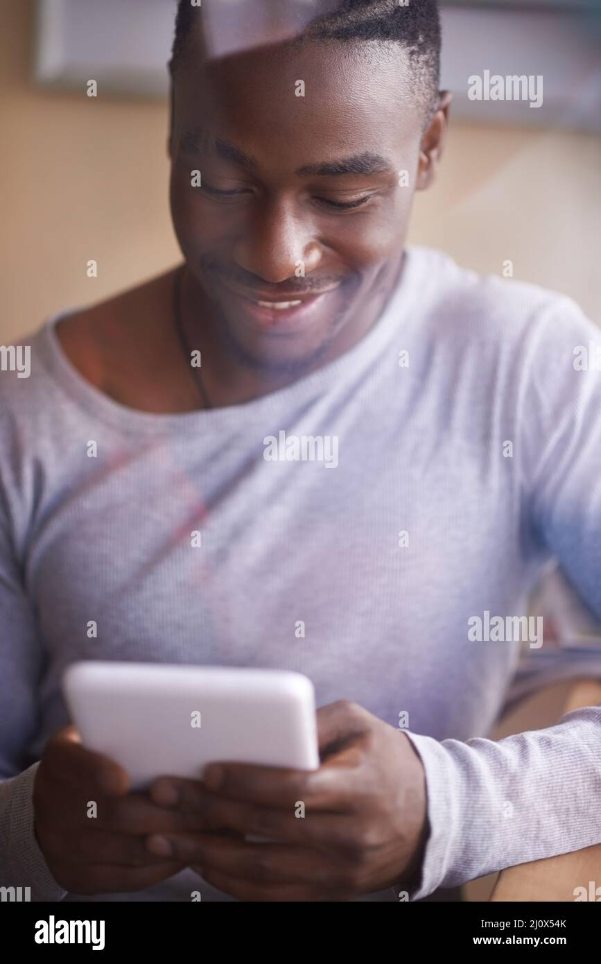 This tablet is extremely user-friendly. Shot of a man using his digital tablet. Stock Photo