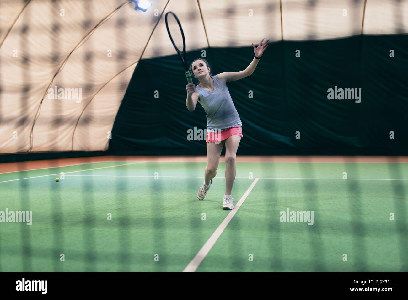 Tennis woman player playing training with racket and ball at court Stock Photo