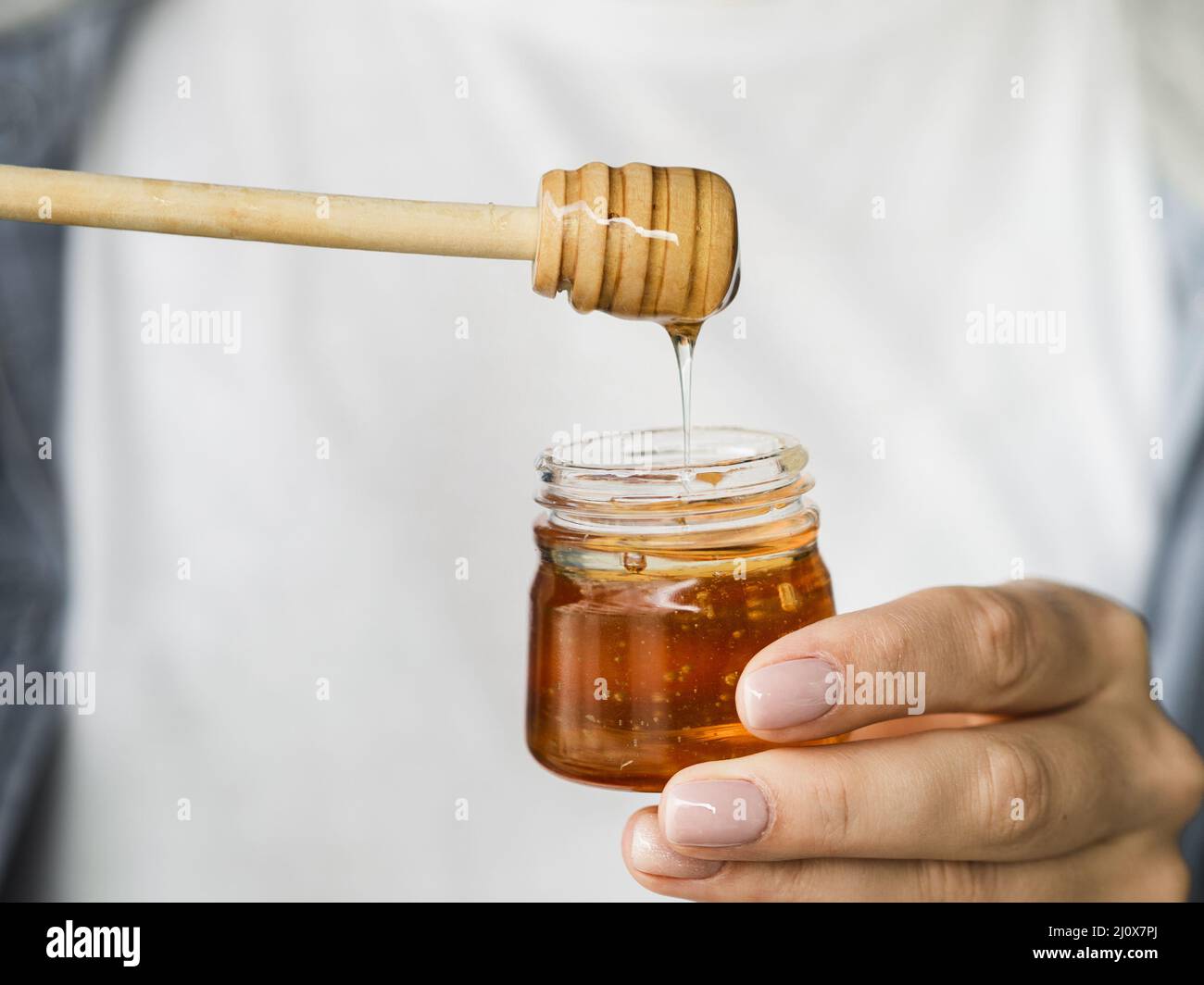 Hand holding sweet honey jar. High quality beautiful photo concept Stock Photo Alamy