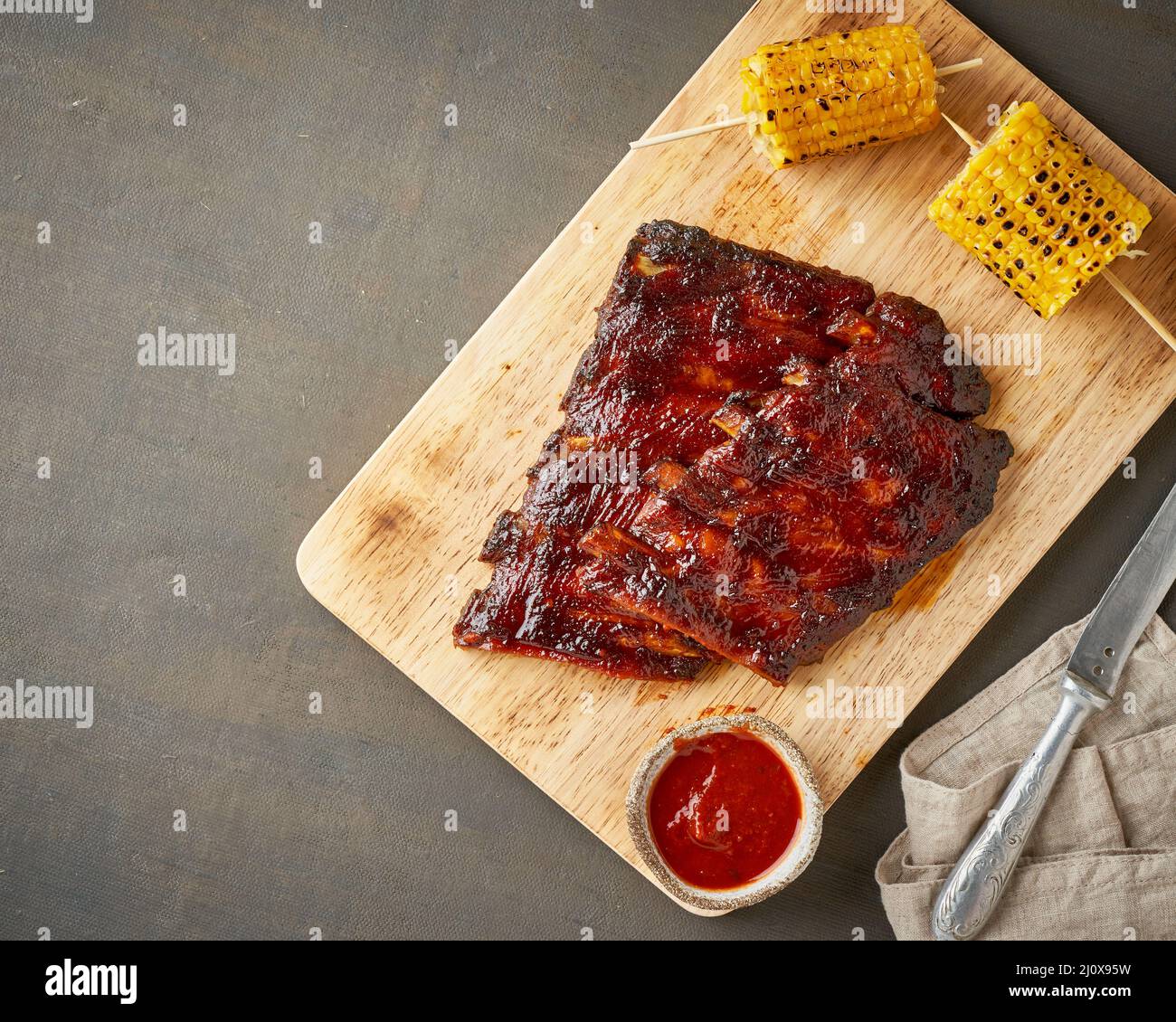 Barbecue pork ribs. Slow cooking recipe. Brown background Stock Photo