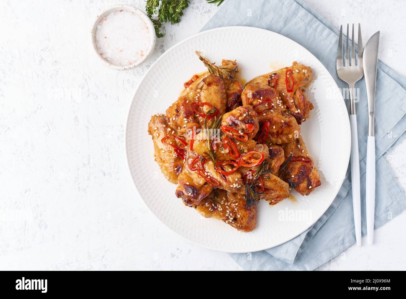 Barbecue chicken wings. Oven baked chiken on plate. Hot korean food. Top view, copy space Stock Photo