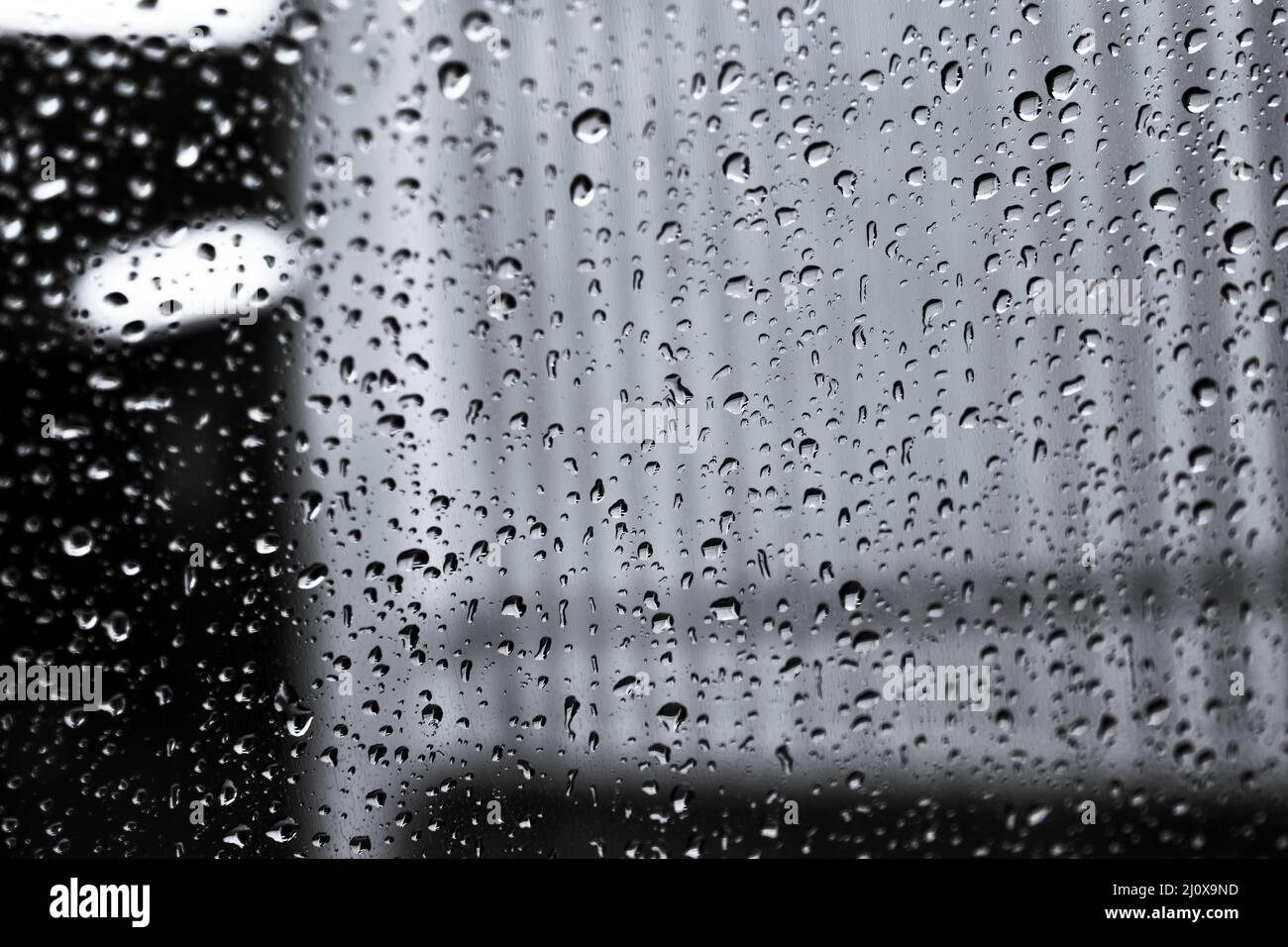 Grayscale view of a rainy window Stock Photo - Alamy