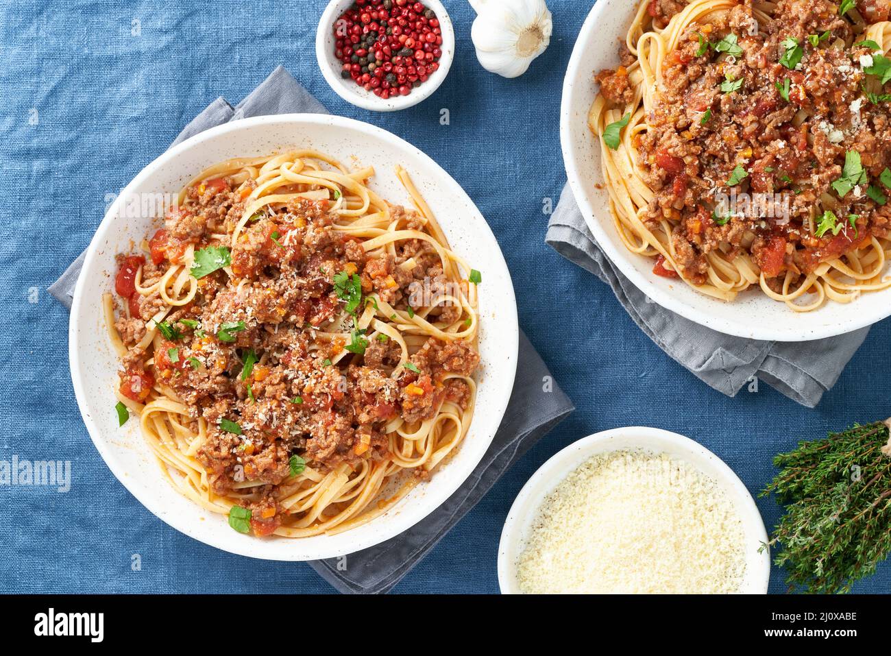 Pasta Bolognese Linguine with mincemeat and tomatoes, parmesan cheese. Top view, close up Stock