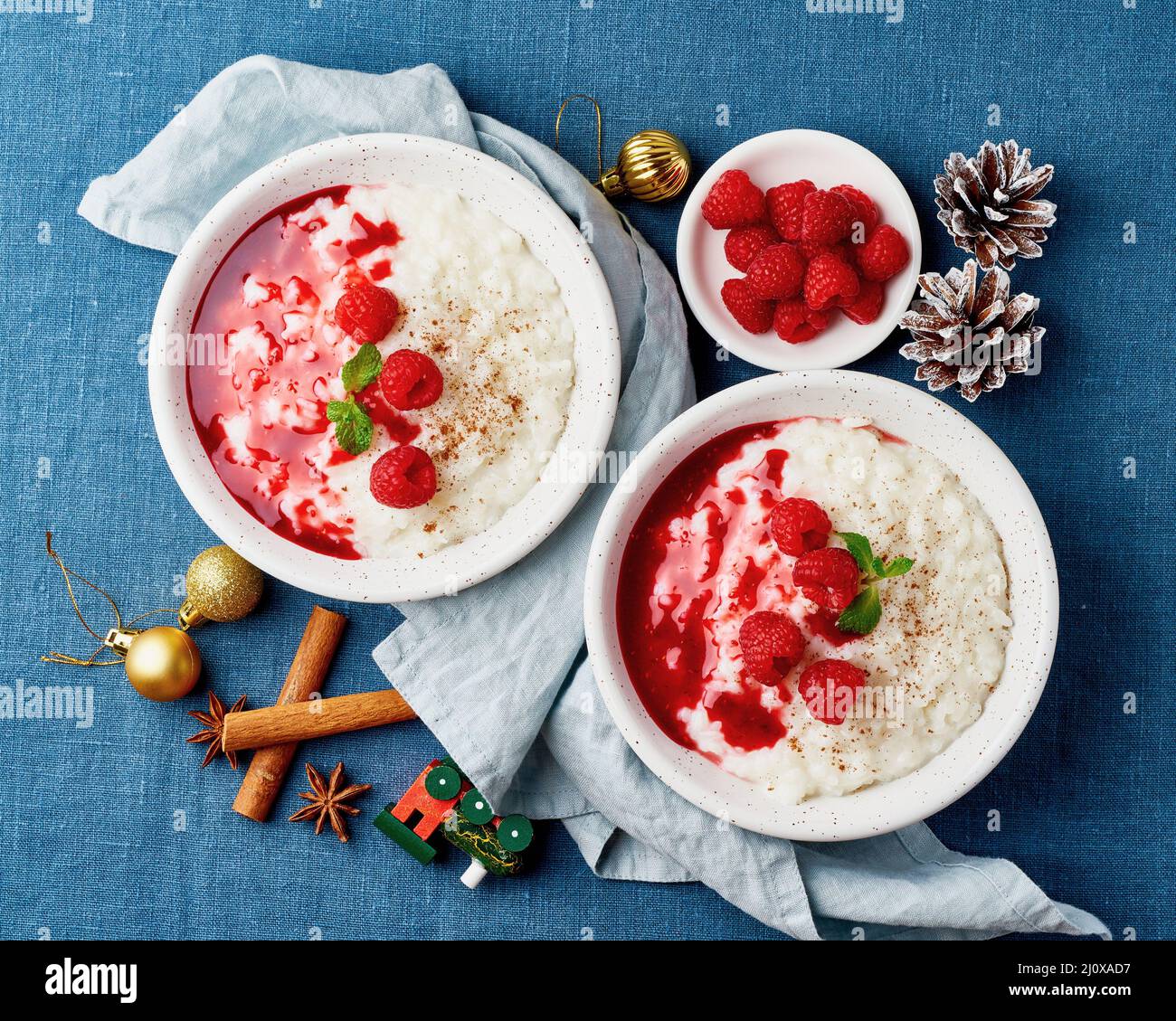 Rice pudding. Christmas food. French milk rice dessert with raspberries. Dark background. Stock Photo