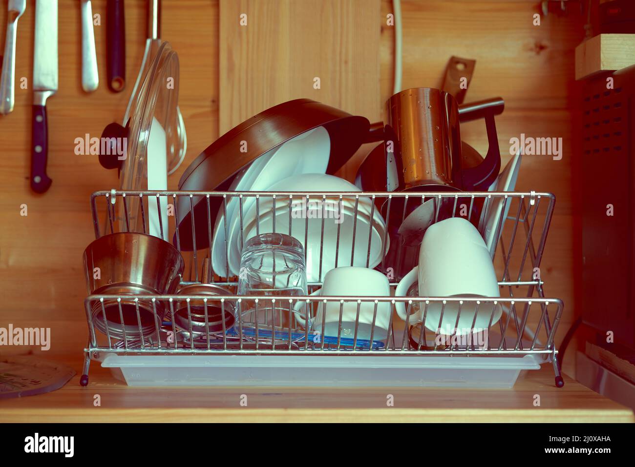 https://c8.alamy.com/comp/2J0XAHA/pure-cleaned-crockery-placed-on-dryer-washed-after-breakfast-in-kitchen-2J0XAHA.jpg