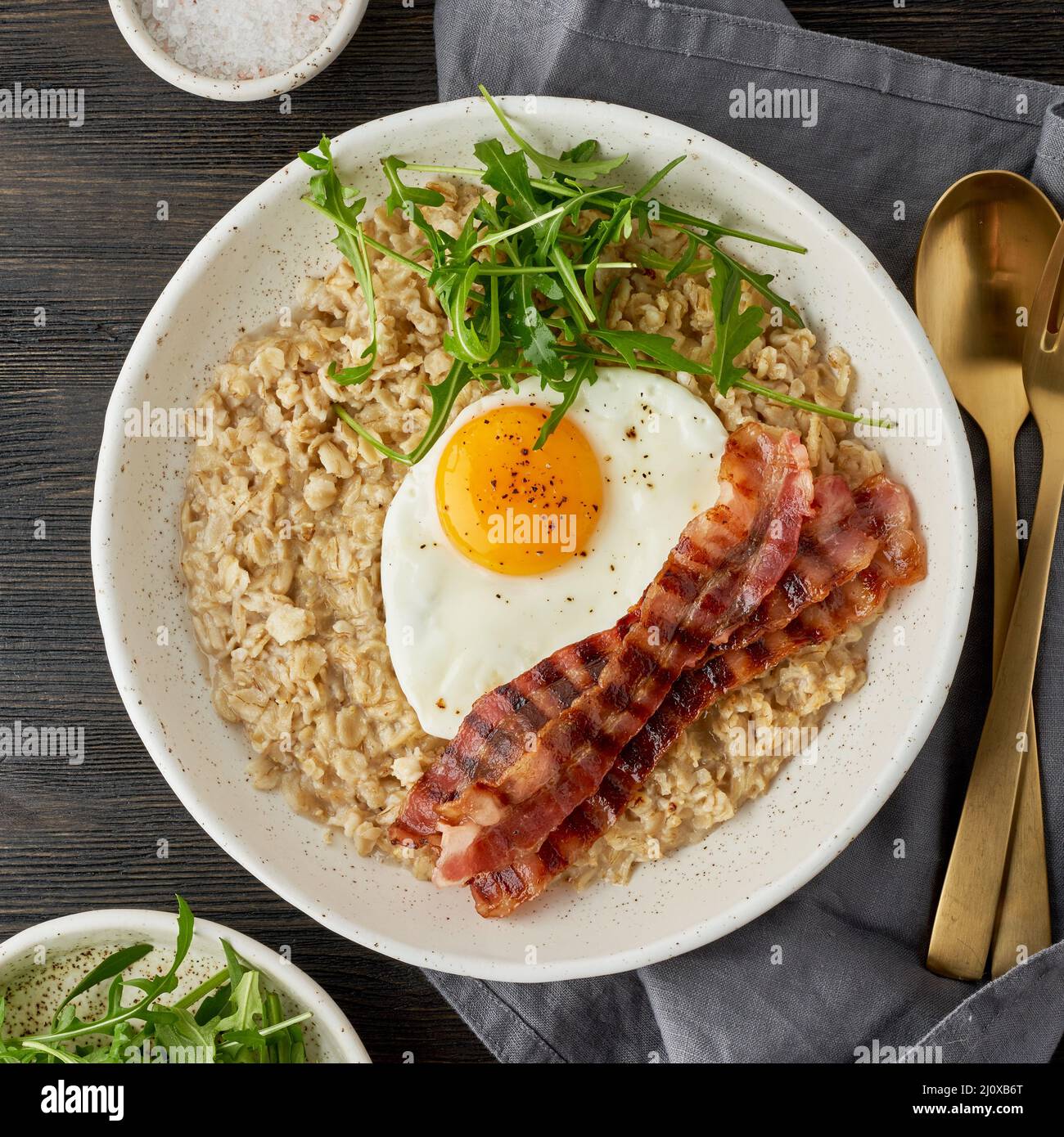 Oatmeal, fried egg and fried bacon. Brutal man sport breakfast. Hearty