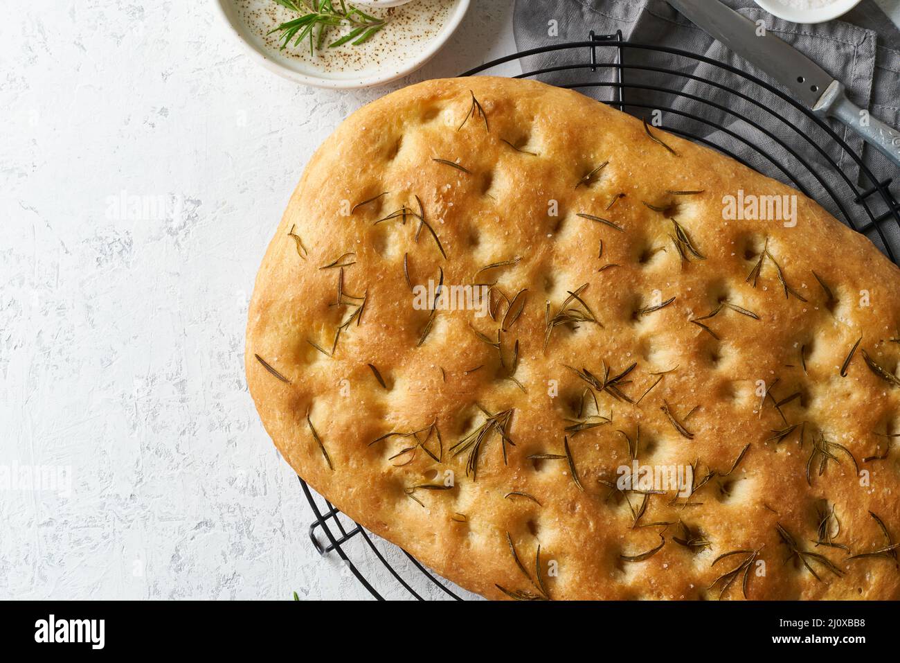 Focaccia, pizza, italian flat bread with rosemary and olive oil on grid Stock Photo Alamy