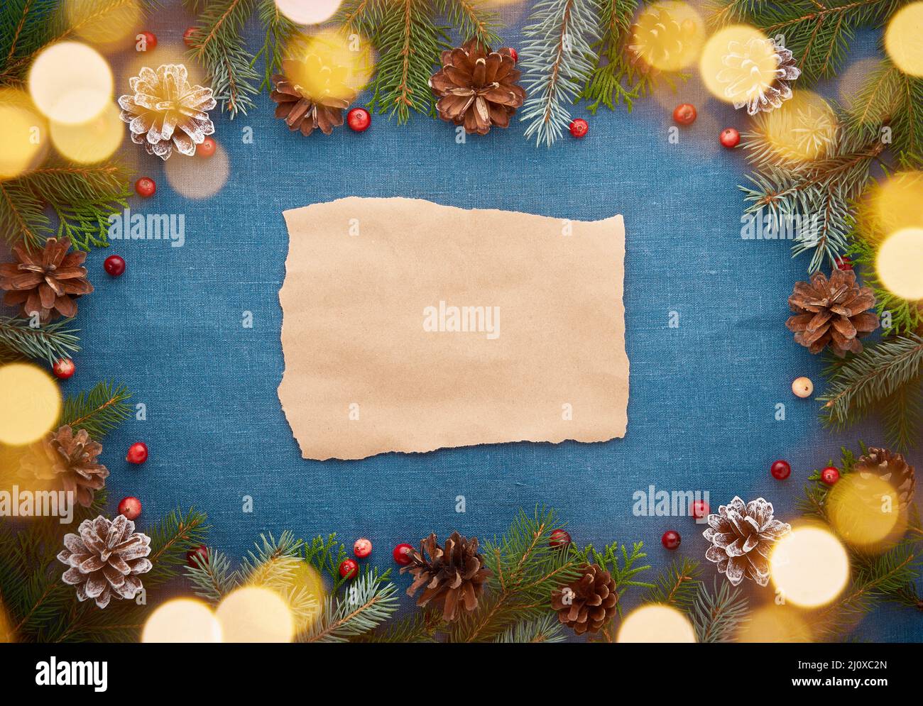 Christmas and Happy New Year dark blue background with craft paper for text and bokeh Stock Photo