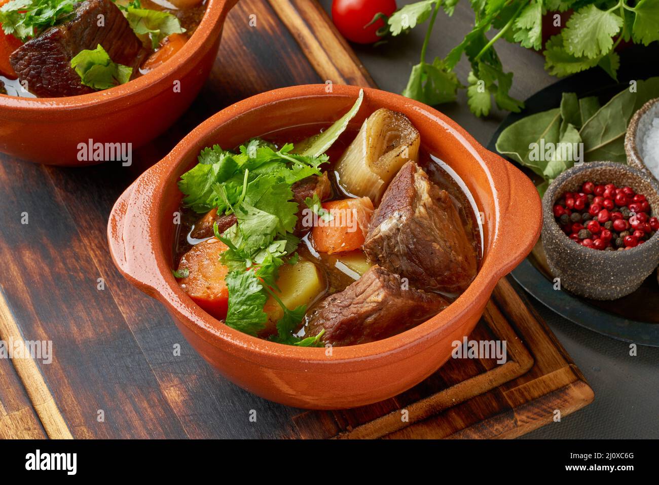 Goulash with large pieces of beef and vegetables. Slow stewing, cooking in two pot or cast-iron pan Stock Photo