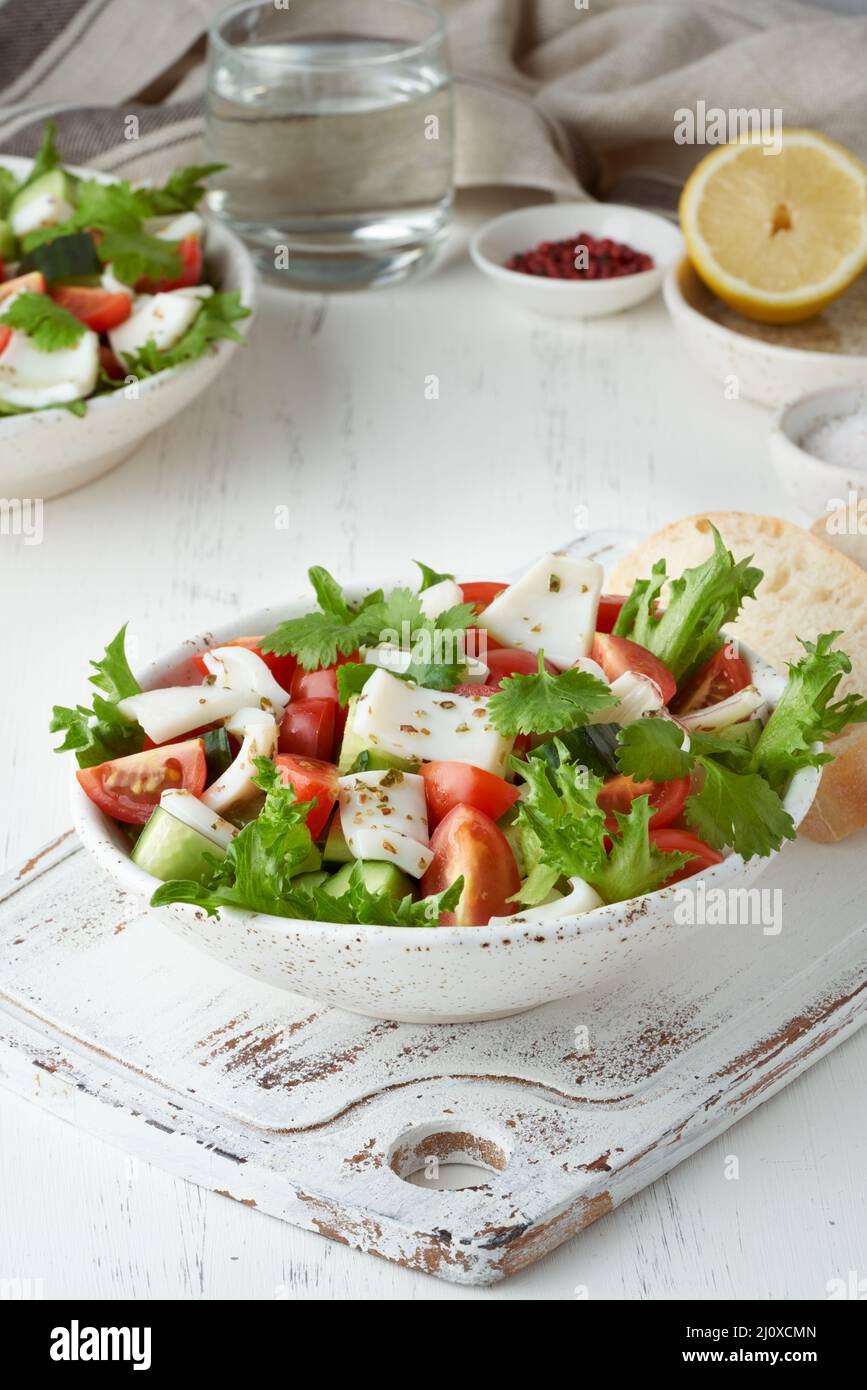 Seafood salad with squid, shrimp, cucumbers, tomatoes and lettuce. LCHF