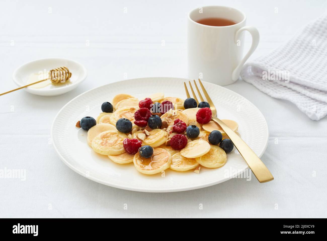 Tiny pancakes, small thin funny crumpet, children's food. Stock Photo