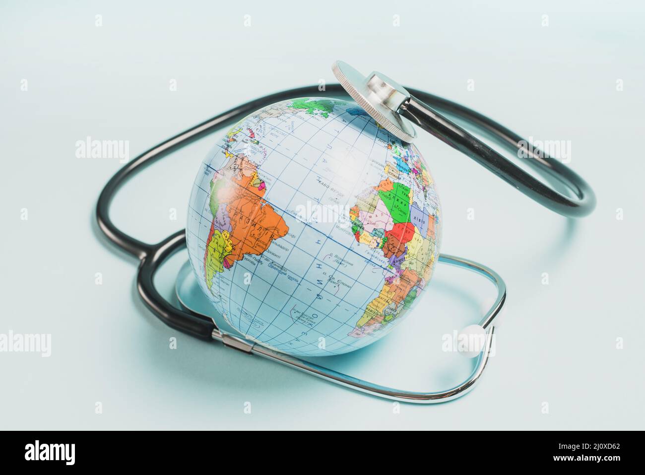Stethoscope globe blue background Stock Photo Alamy