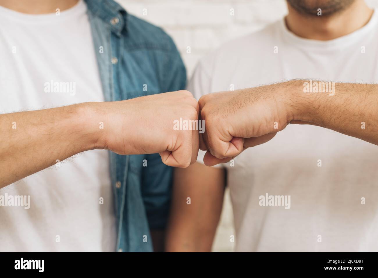 Close up male friend touching fist. High quality beautiful photo concept Stock Photo