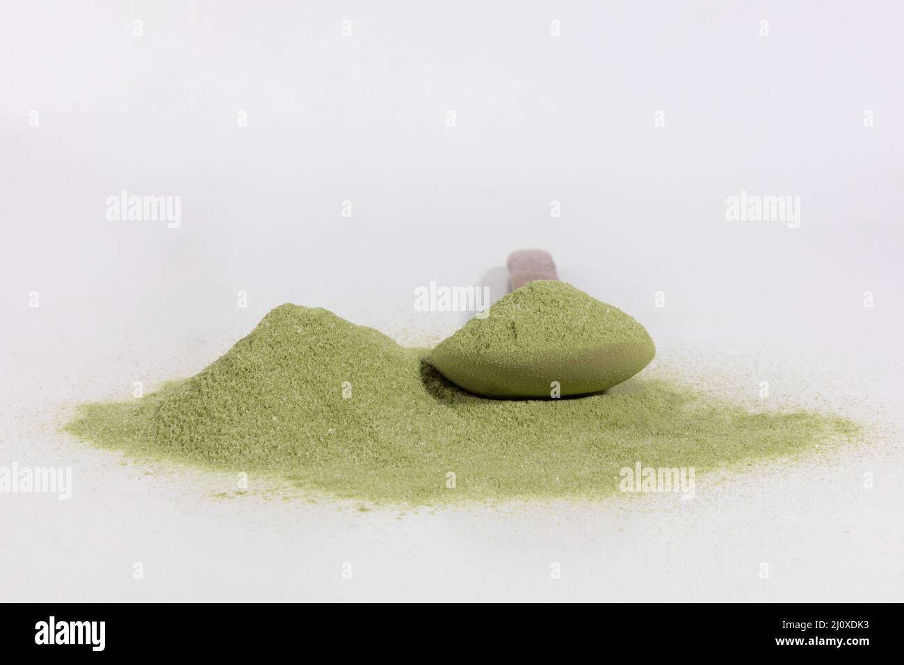 Matcha green tea powder and spoon in white background Stock Photo Alamy