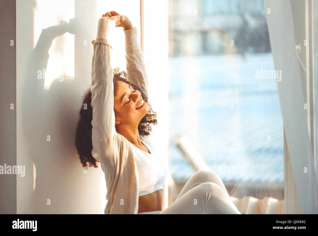 Happy relaxed African American ethnicity girl with closed eyes sitting ...