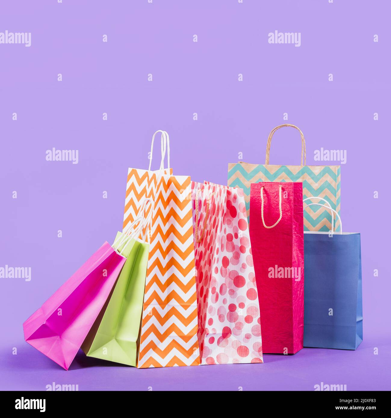 Colorful empty shopping bags purple background. High quality beautiful photo concept Stock Photo