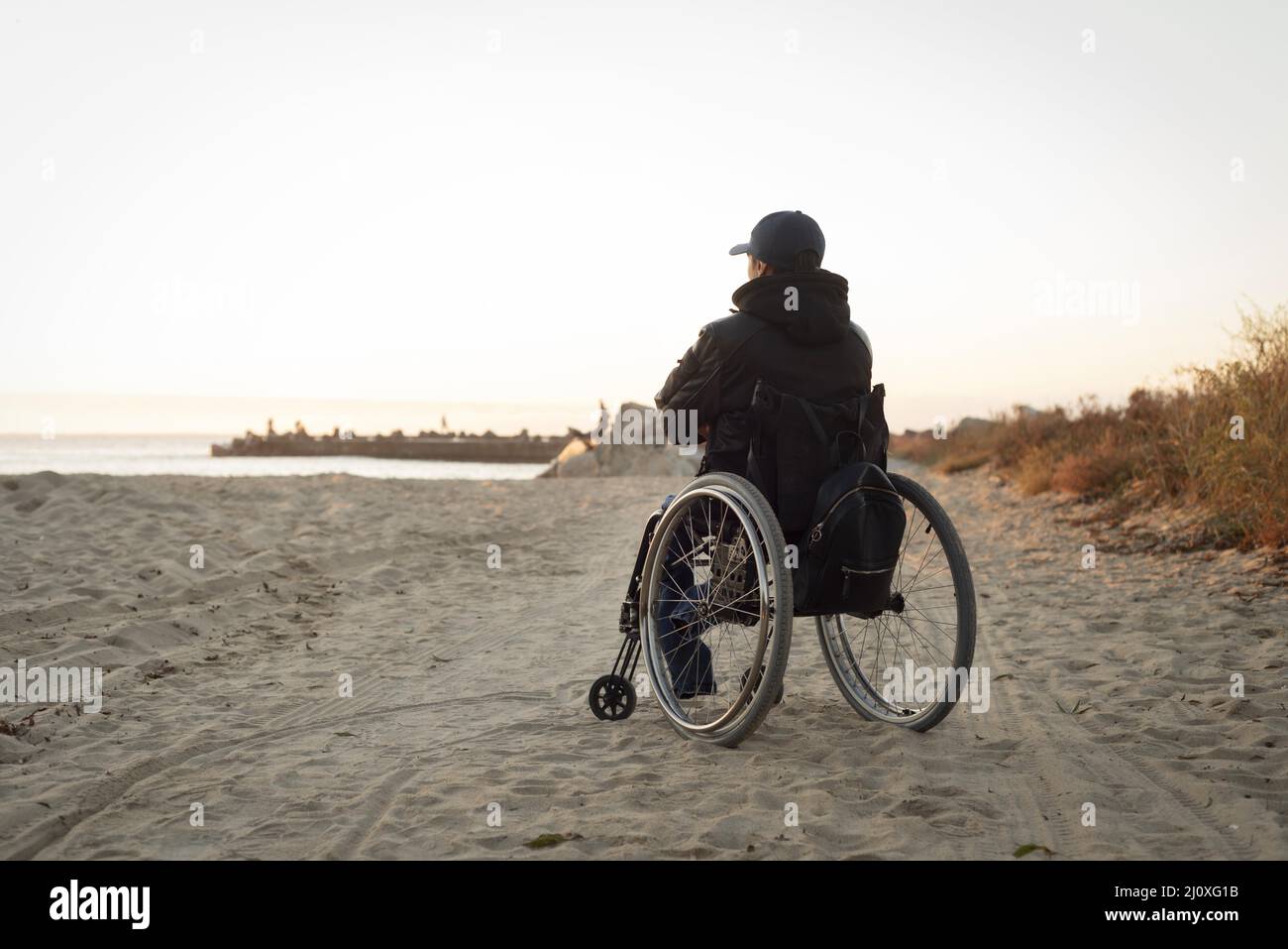 Full shot disabled man beach Stock Photo