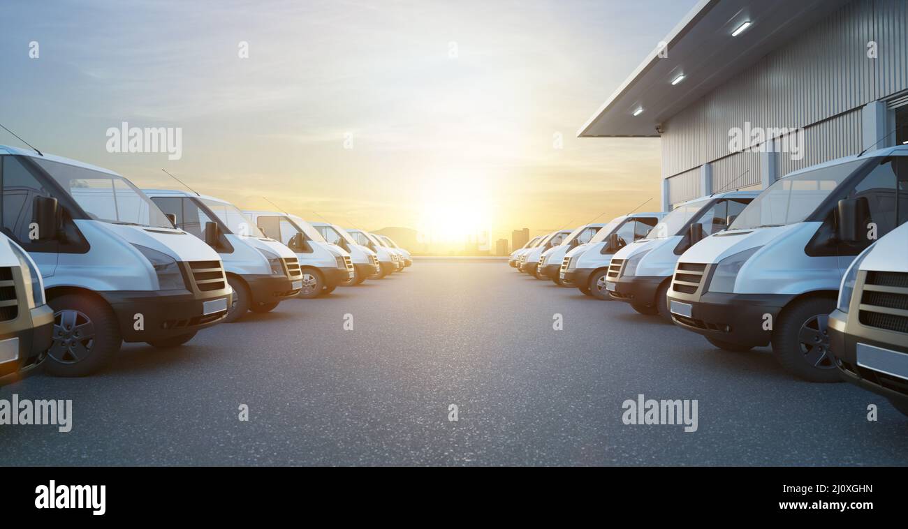 Commercial vans in two row with empty floor and factory building behide. Express delivery and shipment service concept. 3d rende Stock Photo